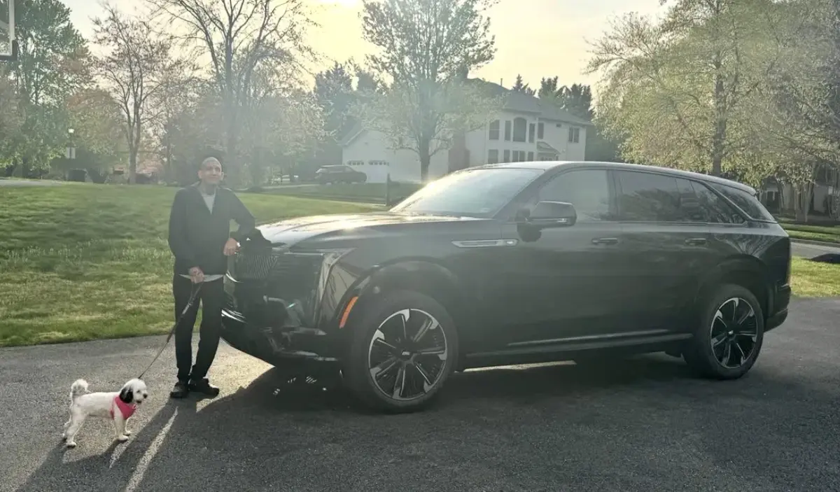 Raoul Shah with a Cadillac Escalade IQ on a Virginia street
