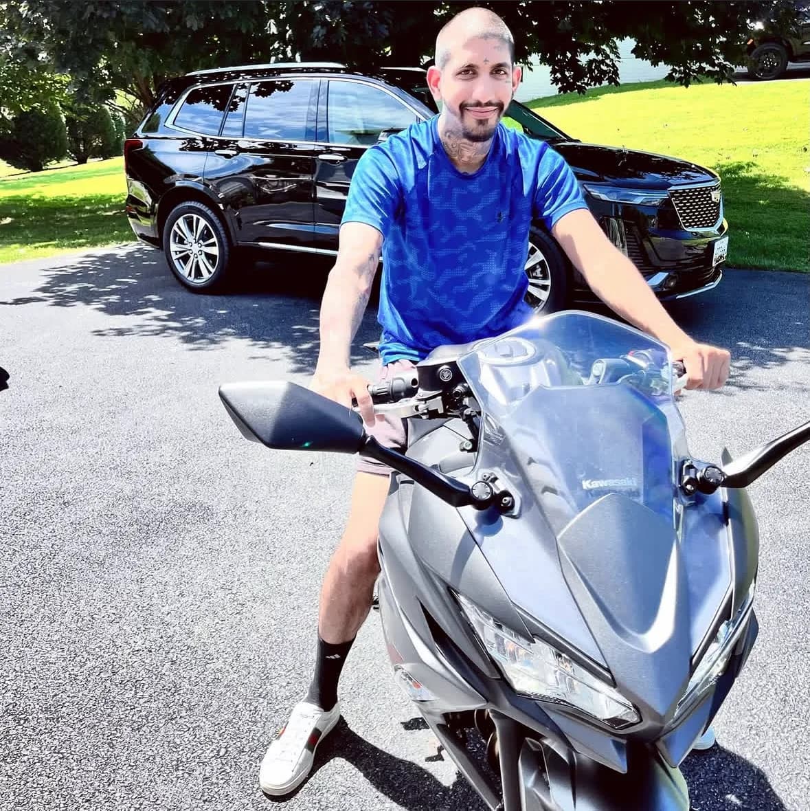 Raoul Shah seated on a Kawasaki motorcycle